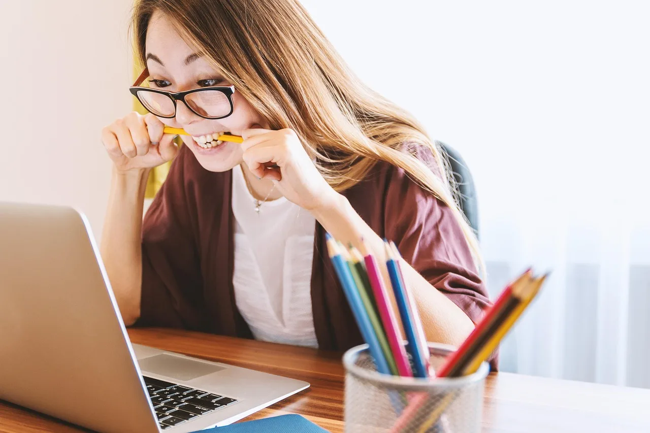 Person at a desk thinking while looking at a laptop, deciding which browser to switch to after Arc shuts down