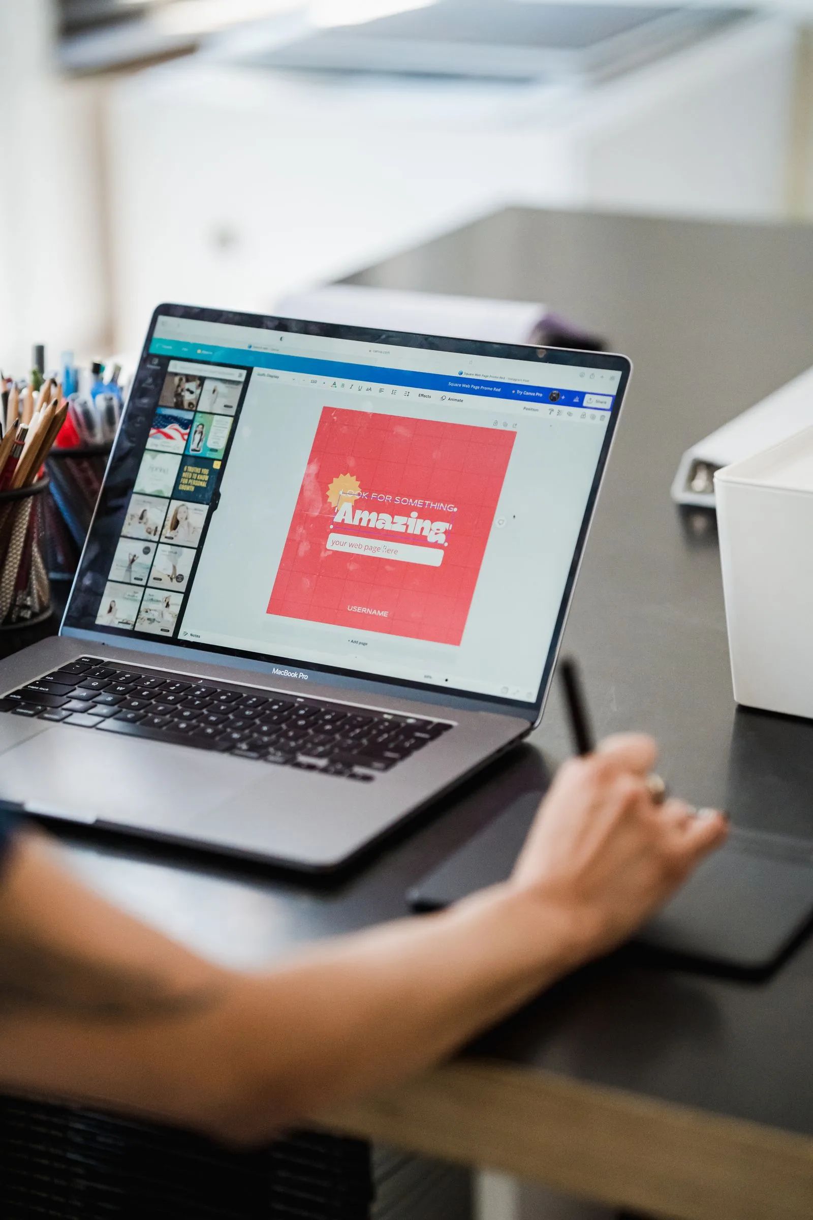 Person using a laptop and graphics tablet for design work at home, illustrating AI image tools like Canva Craft
